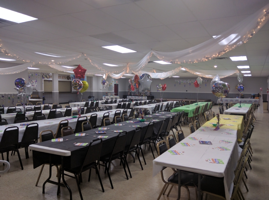 Photo of the hall prepared for an adult's birthday party. Note the bar (shown closed) to the left, for which beer, wine, and liquor and our bartender can be made available, if desired. To the back of the photo is the stage. 